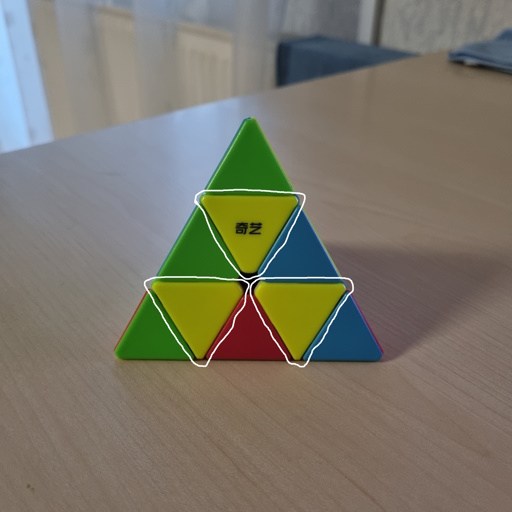 Picture of a Pyraminx where all of the yellow inner pieces are aligned correctly.