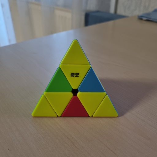 Picture of a Pyraminx where all of the yellow corners and the inner pieces are aligned correctly.