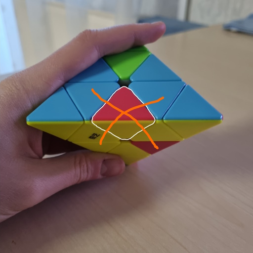 Picture of a Pyraminx where an edge has been inserted at the wrong position