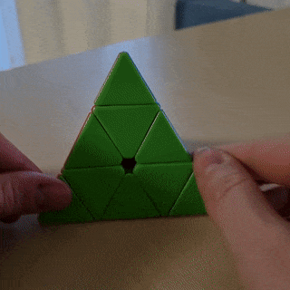 GIF of a solved Pyraminx spinning on a table